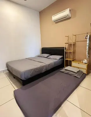 a bedroom with a bed and a air conditioner at Taiping Centre Point Suite 9 by BWC in Taiping