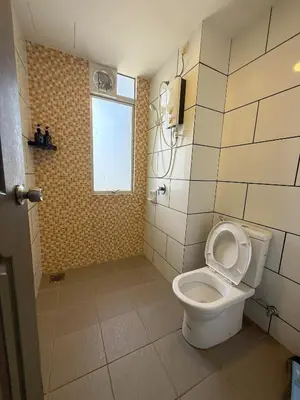 a bathroom with a toilet and a window at Taiping Centre Point Suite 10 by BWC in Taiping