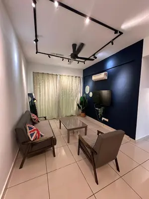 a living room with a couch and chairs and a blue wall at Taiping Centre Point Suite 10 by BWC in Taiping