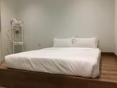 a large white bed with white sheets and pillows at PM Octagon Ipoh Duplex Suite (4-12paxs) in Ipoh