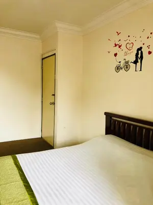a bedroom with a bed with butterflies on the wall at Hotel Chua Gin in Cameron Highlands