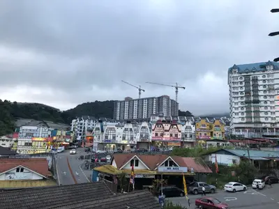 a city with buildings and cars on a street at Hotel Chua Gin in Cameron Highlands