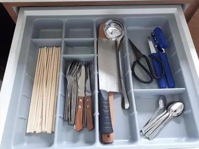 a drawer filled with utensils and other kitchen items at Greenville Homestay in Balik Pulau