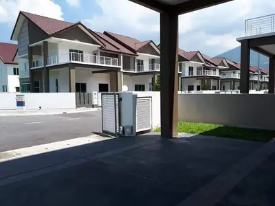 an object sitting in the middle of a parking lot with houses at Greenville Homestay in Balik Pulau