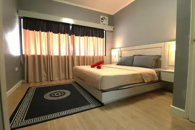 a bedroom with a bed with a red teddy bear on it at Zarania Hillhomes Cameron Highlands in Cameron Highlands