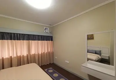 a small bedroom with a bed and a mirror at Zarania Hillhomes Cameron Highlands in Cameron Highlands