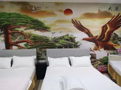 a bedroom with two beds with a painting on the wall at Home Inn Hotel in Ipoh
