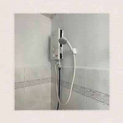 a shower in a bathroom with a shower head at Sea & Wave #1 Coral Bay Apartment in Pangkor