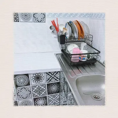 a kitchen sink with a drying rack on top of it at Sea & Wave #1 Coral Bay Apartment in Pangkor
