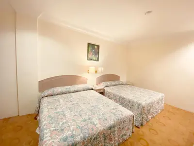 a hotel room with two beds in a room at Hotel Rainbow in Cameron Highlands