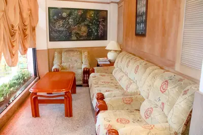 a living room with a couch and a table at Hotel Rainbow in Cameron Highlands
