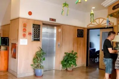 a man standing in a room with an elevator at Hotel Rainbow in Cameron Highlands