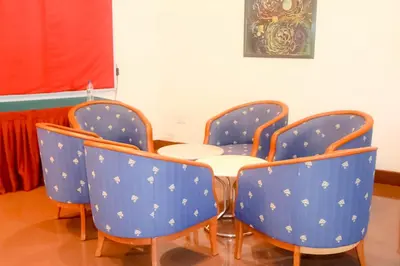 a table and four chairs in a room at Hotel Rainbow in Cameron Highlands