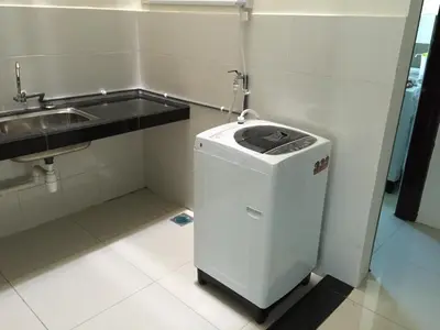 a trash can in a bathroom next to a sink at Kampar Private Roomstay W in Kampar