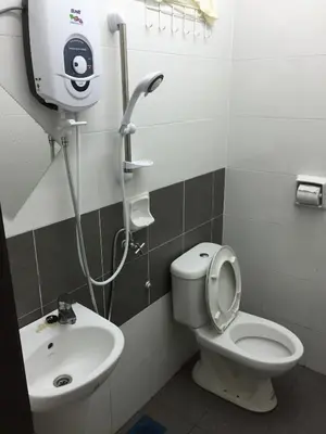 a bathroom with a white toilet and a sink at Kampar Private Roomstay W in Kampar