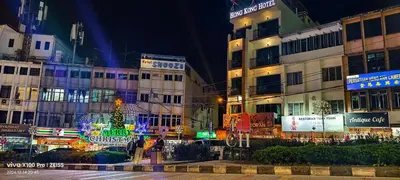 a city at night with a christmas tree and buildings at Hong Kong Hotel in Brinchang
