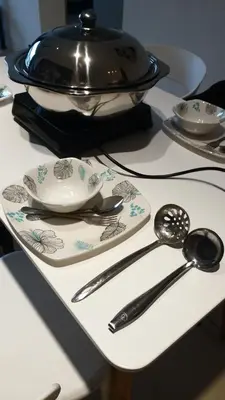 a table with a plate with a bowl and spoons at Misty Wonderland Cameron Next to Night Market 9 PAX in Cameron Highlands