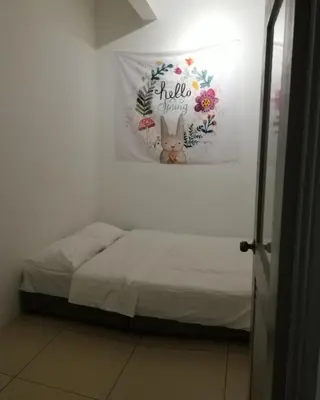 a bedroom with a bed with a flower picture on the wall at Misty Wonderland Cameron Next to Night Market 9 PAX in Cameron Highlands
