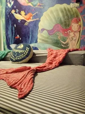 a close up of a bed with a towel on it at Blue Romance Mermaid Cameron Stay 9 pax Next to Night Market in Cameron Highlands