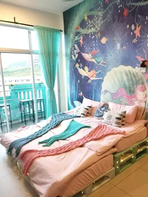 a bedroom with a large bed with a painting on the wall at Blue Romance Mermaid Cameron Stay 9 pax Next to Night Market in Cameron Highlands