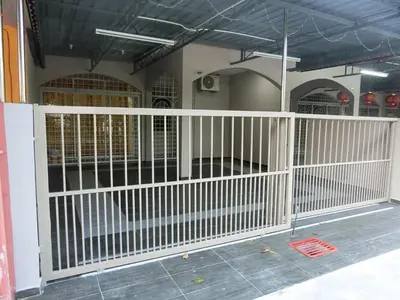 a white fence in front of a building at Taiping Cozy Homestay II in Taiping