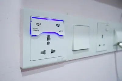 a lightswitch on a wall in a room at Grand FC Hotel in George Town