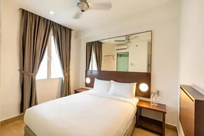 a bedroom with a bed and a large mirror at Tune Hotel Georgetown Penang in George Town