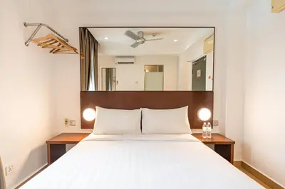 a bedroom with a bed and a large mirror at Tune Hotel Georgetown Penang in George Town