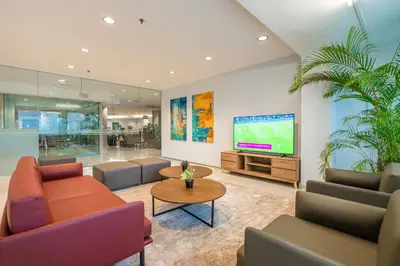 a living room with couches and a flat screen tv at Tune Hotel Georgetown Penang in George Town