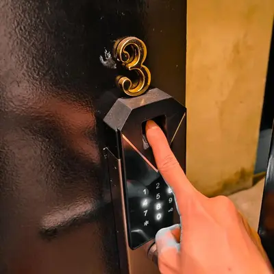 a person is unlocking a door with a number three on it at Beds In Garden Hostel in Ipoh