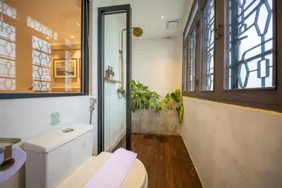 a bathroom with a toilet and a window at Manhattan Residence in George Town