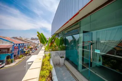 a building with glass windows and a street at Manhattan Residence in George Town