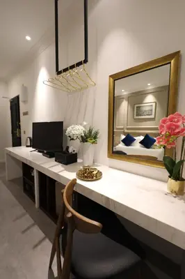 a bedroom with a desk with a mirror and a bed at Manhattan Residence in George Town
