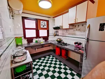 a kitchen with a refrigerator and a checkered floor at My Home Apartment - Villa Dahlia Apartment in Cameron Highlands