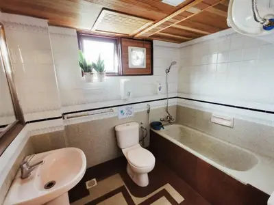 a bathroom with a tub and a toilet and a sink at My Home Apartment - Villa Dahlia Apartment in Cameron Highlands