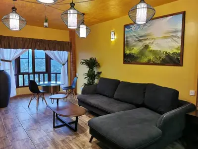 a living room with a couch and a table at My Home Apartment - Villa Dahlia Apartment in Cameron Highlands