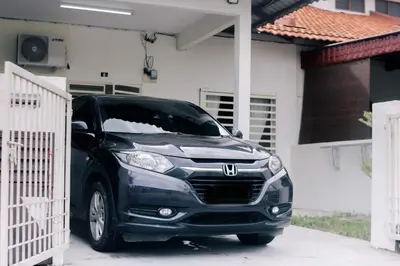 a black car parked in front of a house at TheDaun Homestay Seri Iskandar, Perak in Seri Iskandar