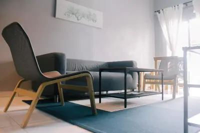 a living room with two chairs and a table at TheDaun Homestay Seri Iskandar, Perak in Seri Iskandar