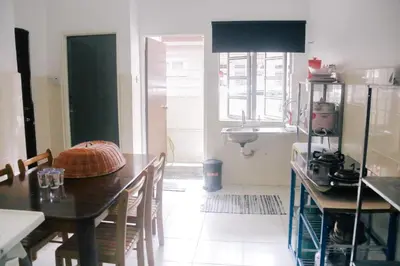 a kitchen with a table and a sink at TheDaun Homestay Seri Iskandar, Perak in Seri Iskandar