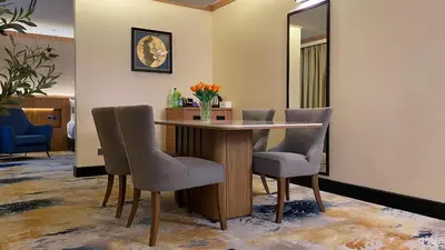 a dining room with a table and chairs at Kinta Riverfront Hotel & Suites in Ipoh