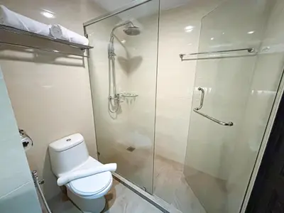 a bathroom with a toilet and a glass shower at Kinta Riverfront Hotel & Suites in Ipoh