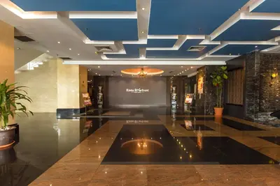 a lobby with a blue ceiling in a building at Kinta Riverfront Hotel & Suites in Ipoh