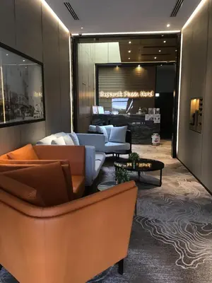 a living room with couches and a table at Ropewalk Piazza Hotel Managed by The Ascott Limited in George Town