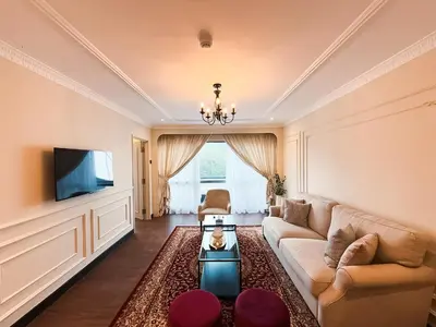 a living room with a couch and a tv at Wyndham Garden Shahzan Fraser's Hill in Bukit Fraser