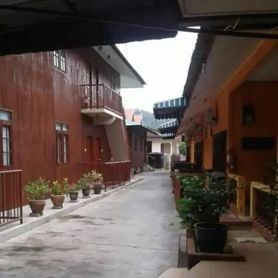 an empty alley with potted plants in a building at Nipahmas Chalet in Pangkor