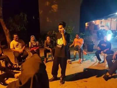 a man standing in front of a group of people at Nipahmas Chalet in Pangkor