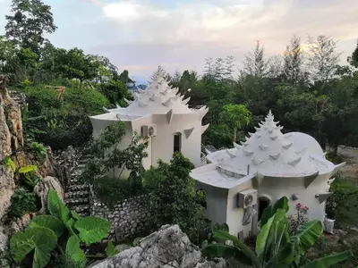 a white building with white roofs on a mountain at Rocky Farm in Ipoh