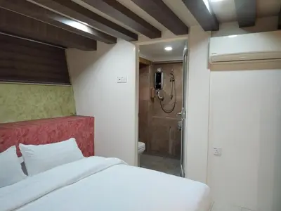 a bedroom with a white bed and a shower at Rocky Farm in Ipoh