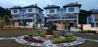 a park with a fountain in front of some buildings at Zinnia Residence Tanah Rata in Cameron Highlands