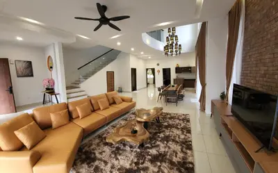 a living room with a couch and a fireplace at Zinnia Residence Tanah Rata in Cameron Highlands